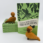 Hardcover editions of Outdoor Reflections for Bird Watchers by Harold E. Kohn displayed with wooden bird figures