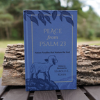 Hardcover edition of Peace from Psalm 23 by Harold E. Kohn, displayed outdoors with its blue illustrated cover featuring a lamb