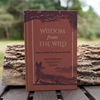 Hardcover edition of Wisdom from the Wild by Harold E. Kohn displayed outdoors in a natural woodland setting