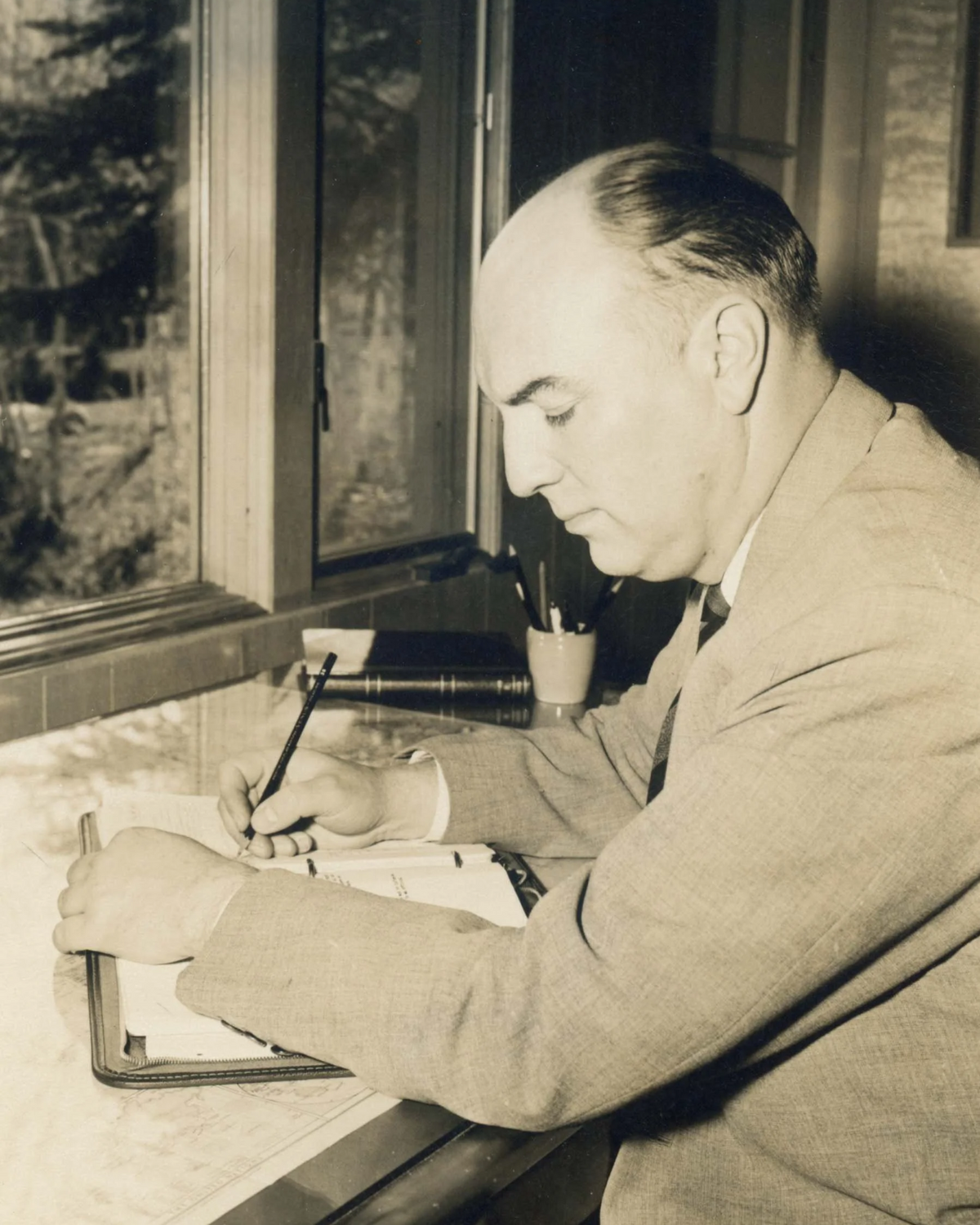 Harold E. Kohn at his writing and drawing desk at hidden brook